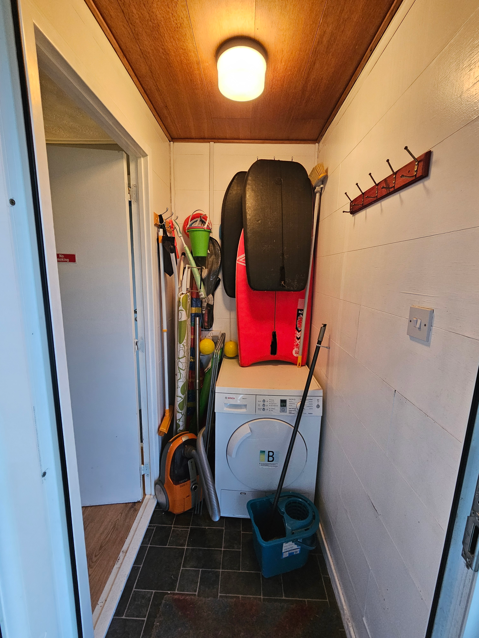 One of the entrances to the lodge, which has a few beach boards, buckets/spades, rackets, all you would need for the beach. Also has a tumble dryer and clothes horse