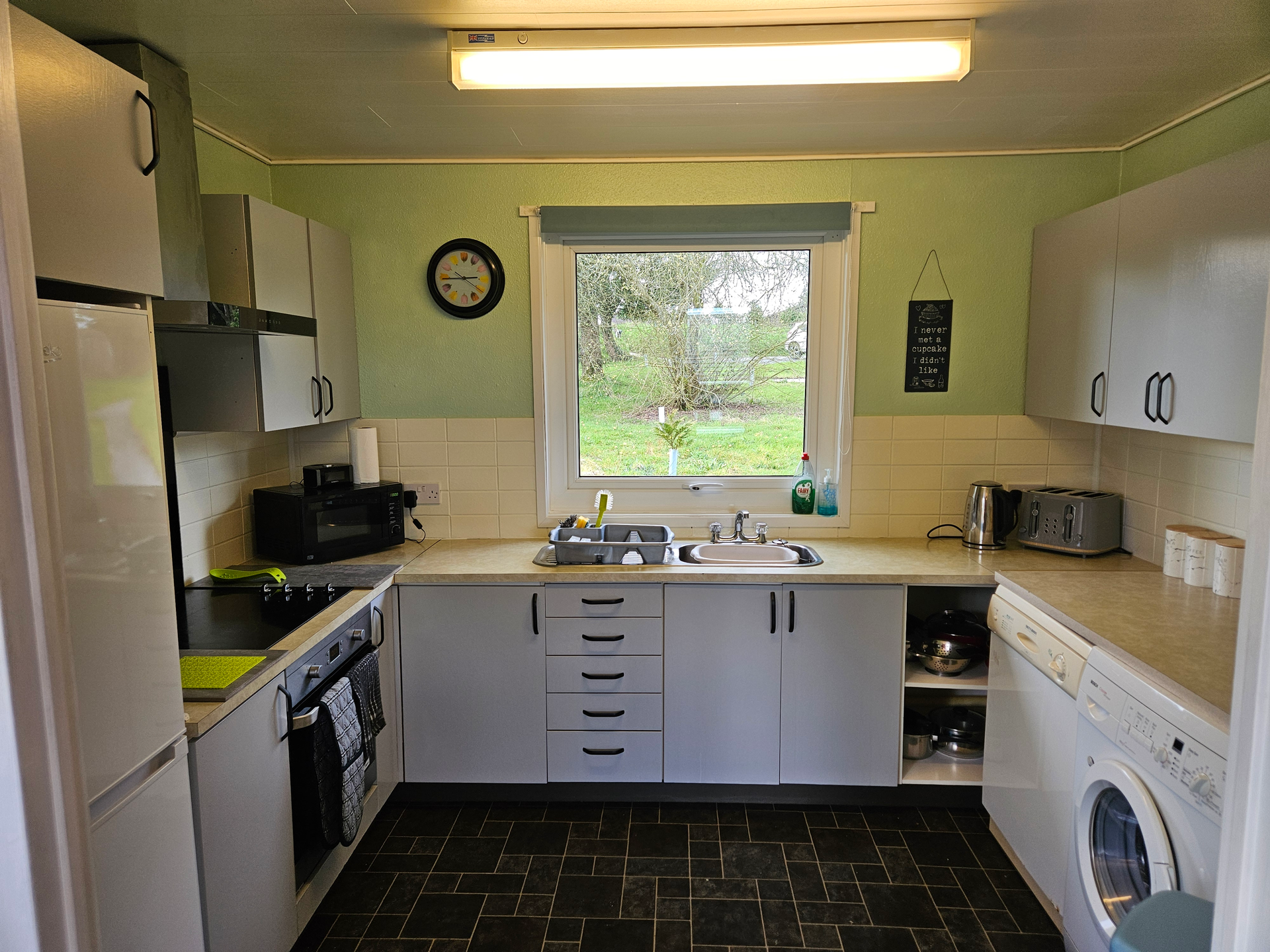 The kitchen which has all your main necessities, from oven, microwave, kettle, toaster, dishwasher, washing machine etc