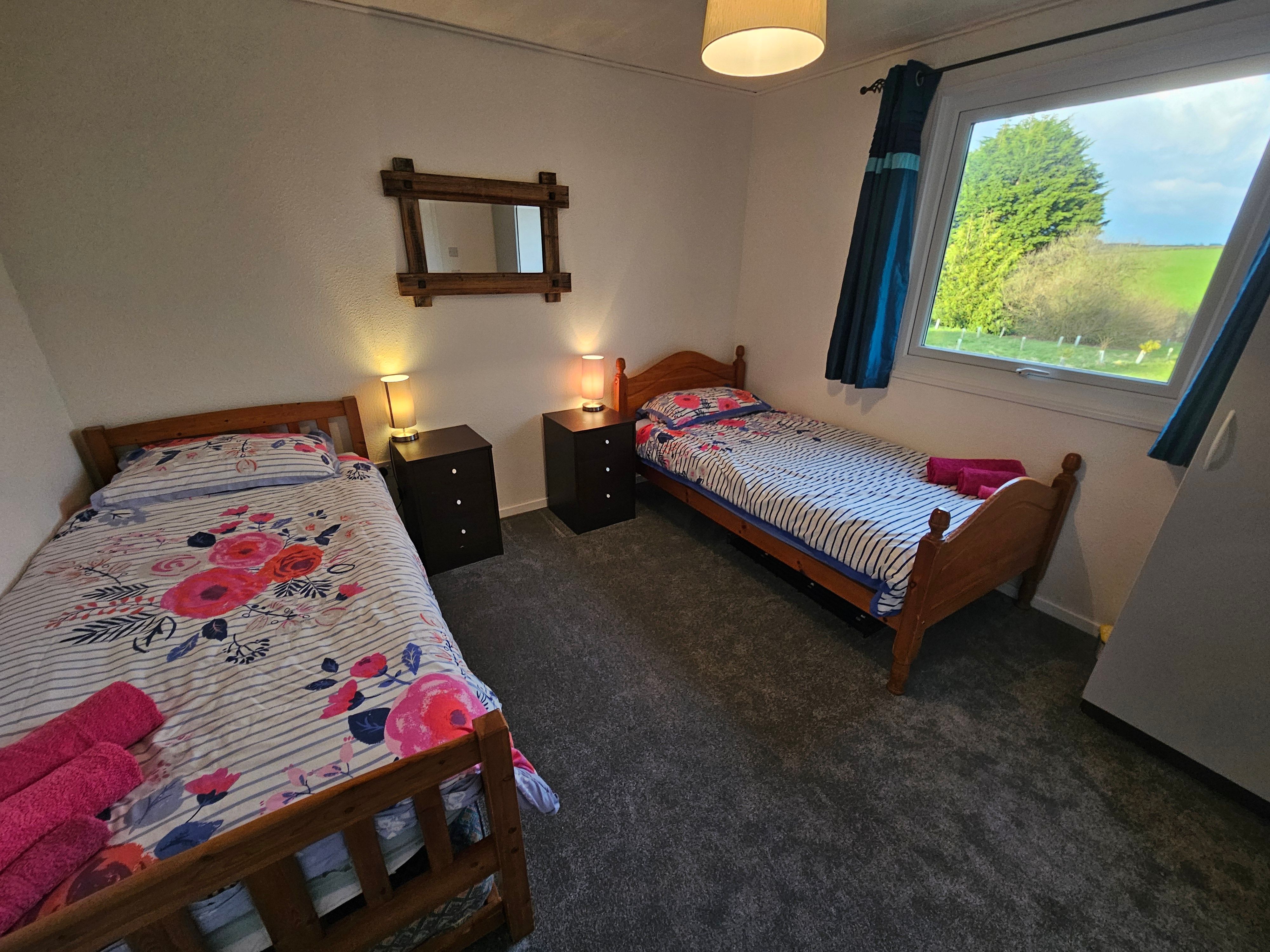 The second bedroom which has two single beds in, a wardrobe and a games cupboard